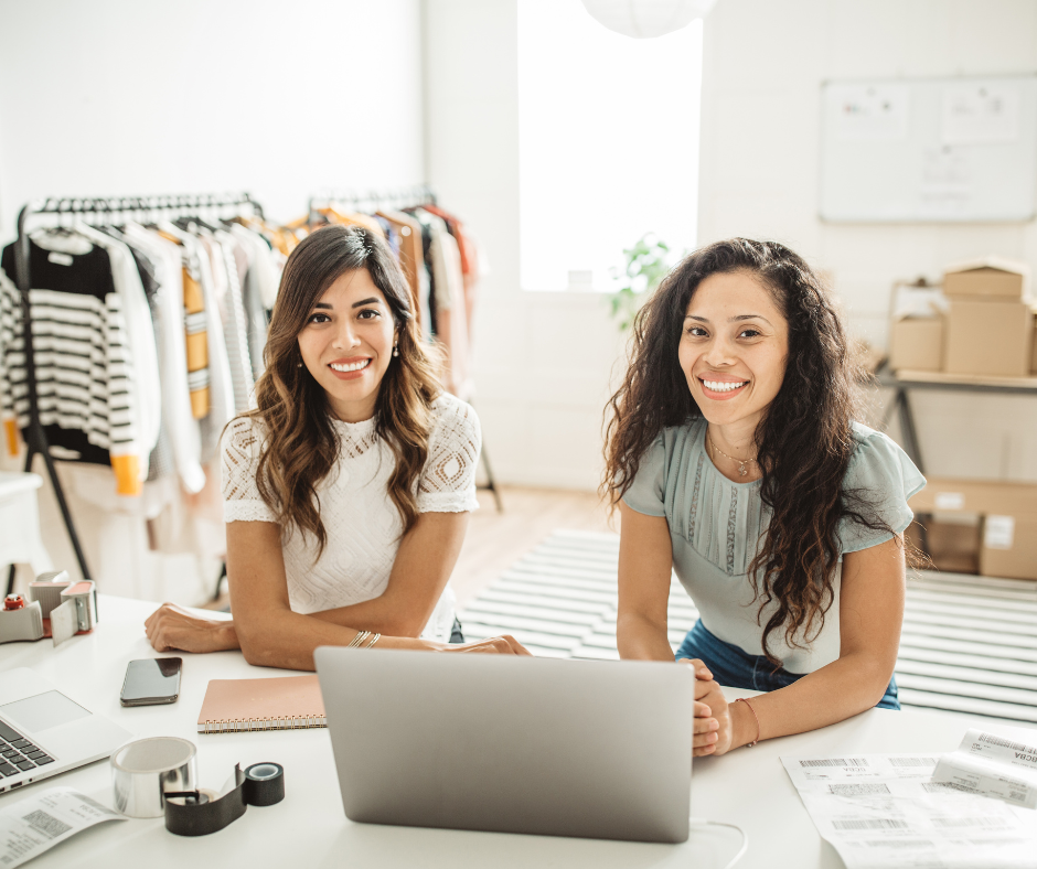 Two women entrepreneurs reviewing personal credit and business funding options together on a laptop