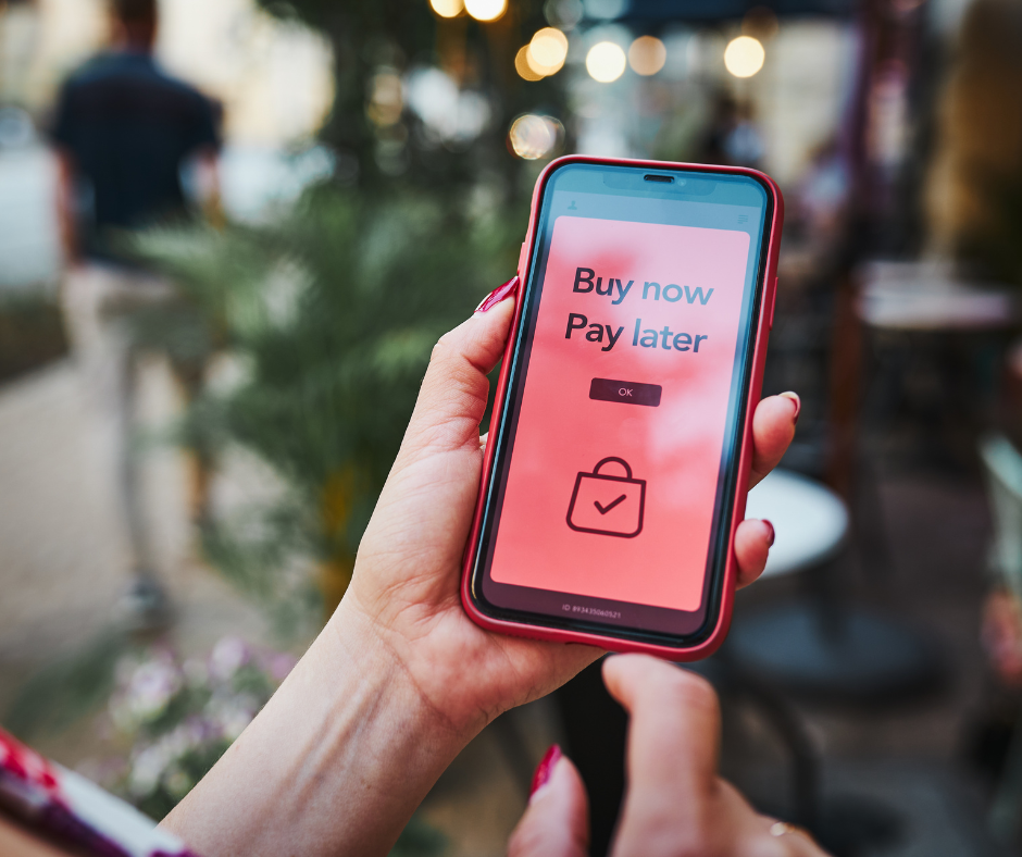 Person holding phone with notification representing phantom debt appearing unexpectedly on a credit report